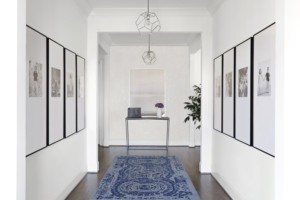 Home interior entryway with pictures on walls