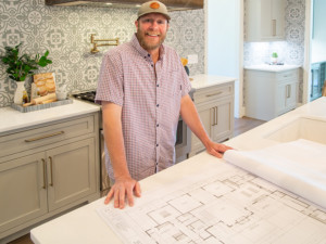 Baird Graham in custom home kitchen with blueprints