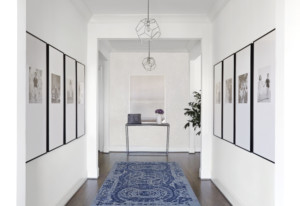 Entryway with pictures lining walls