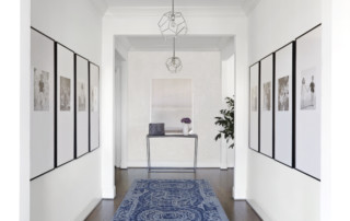 Entryway with pictures lining walls