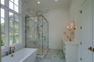 Custom master bathroom with shower and bathtub