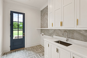 Laundry hookup area with sink and exterior door